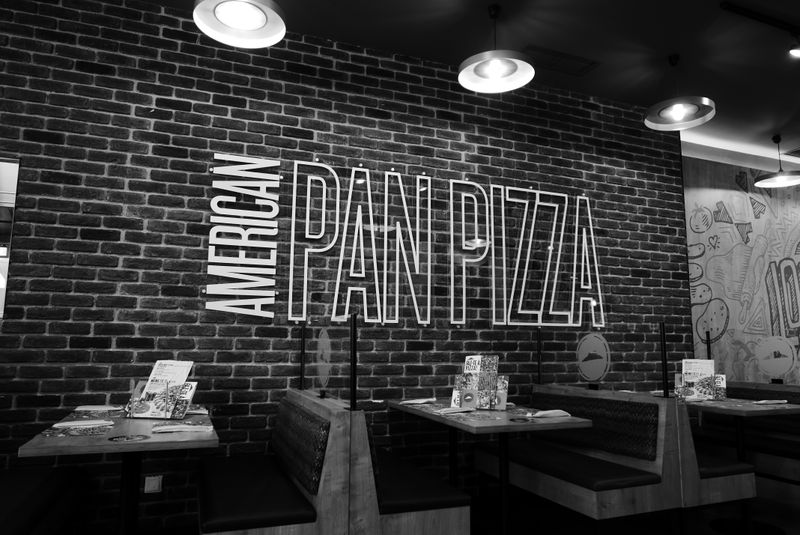 Inside Anthony's coal fired pizza restaurant — warm, inviting dining room